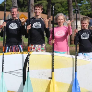 Paddleboarders gliding on calm water at sunrise