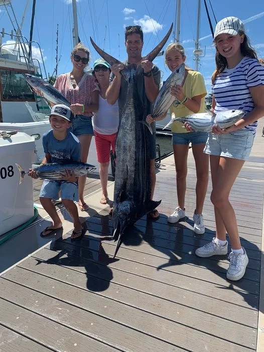 Fishing boat cruising along Kauai coastline on deluxe tour
