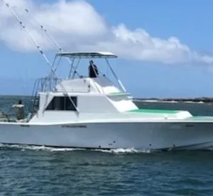 Private six hour sportfishing boat cruising near Kauai island