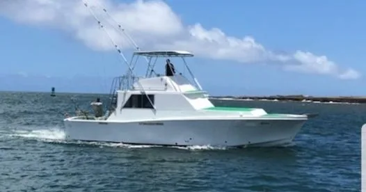 Private six hour sportfishing boat cruising near Kauai island