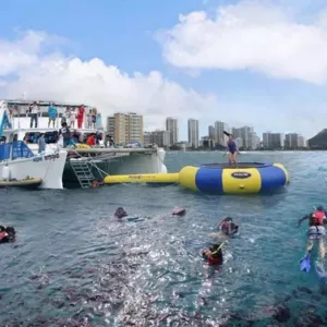 Large boat cruising Waikiki waters on tour
