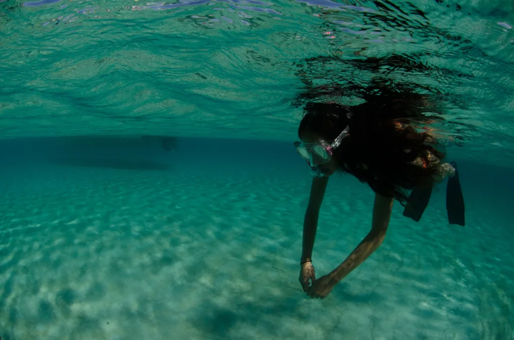 Junior freediver practicing breath-holding techniques in pool