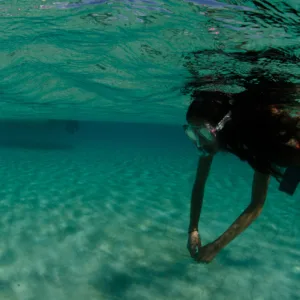 Junior freediver practicing breath-holding techniques in pool