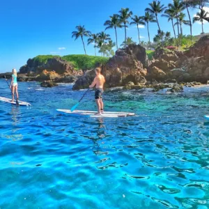 Stand up paddleboarders exploring South Maui coastline waters