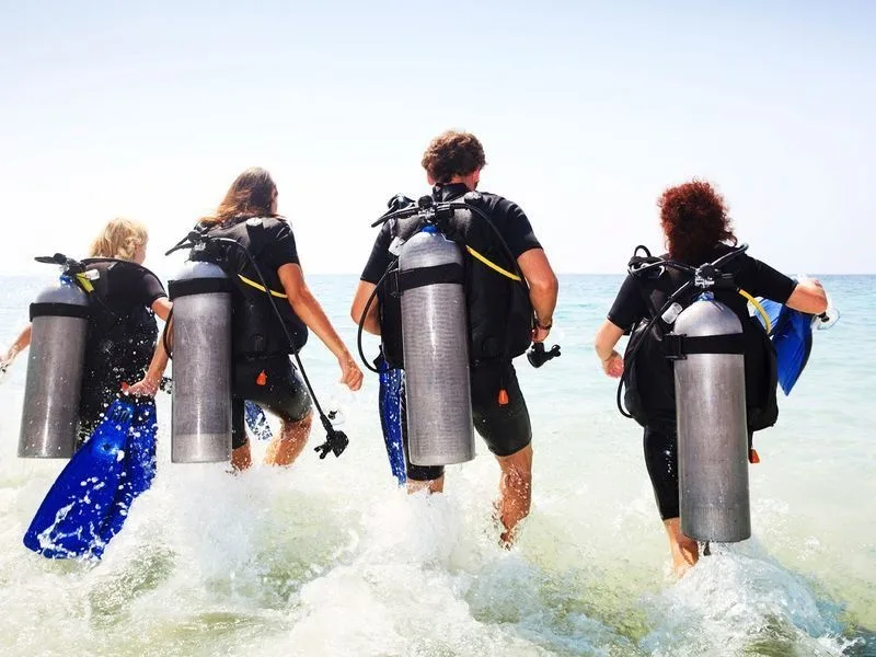 Scuba diver preparing for shore dive near Oahu beach