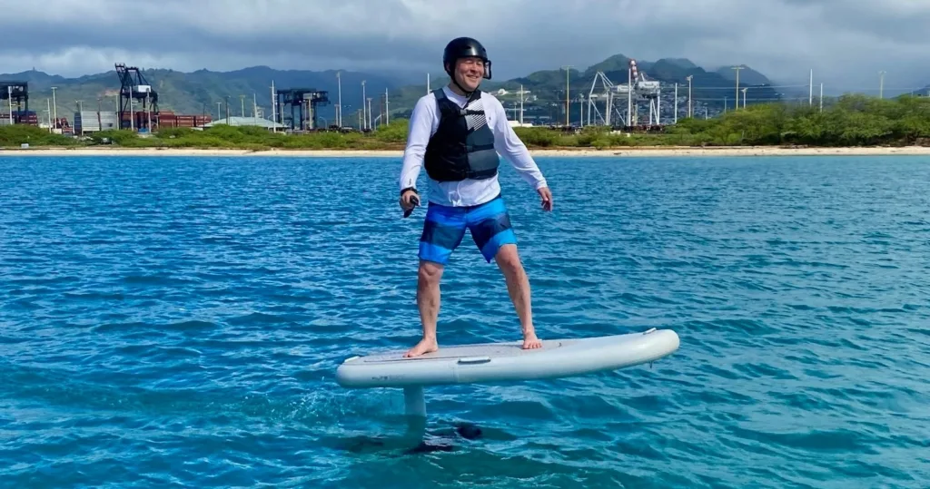 Solo rider experiencing mid-length eFoil ride on calm water