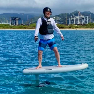 Solo rider experiencing mid-length eFoil ride on calm water