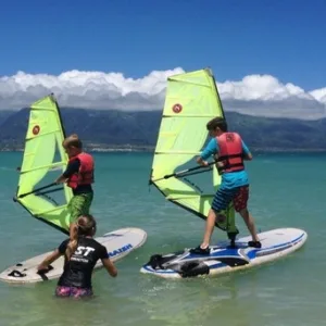 Instructor teaching beginner windsurfing lessons on Maui beach