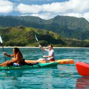 Boat exploring calm bay waters in Kauai afternoon