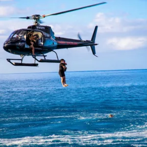 Helicopter making a dramatic jump over scenic landscape