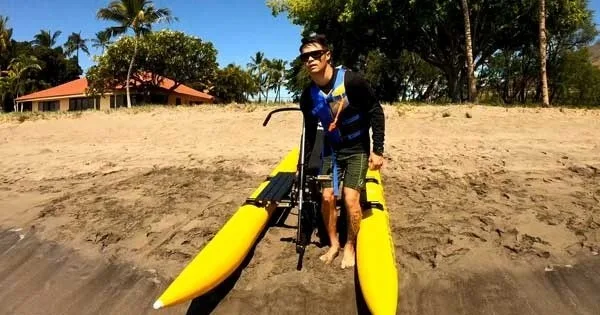 Cyclists riding water bikes across Makena Bay’s clear waters