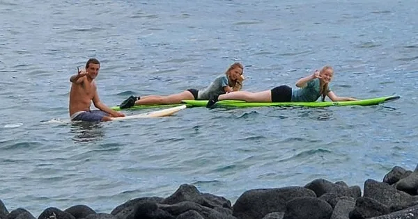 Small group participating in a semi-private surf lesson in Kona