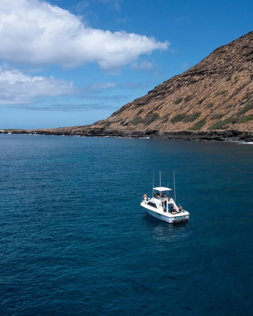 Custom day trip boat anchored near vibrant snorkeling spot