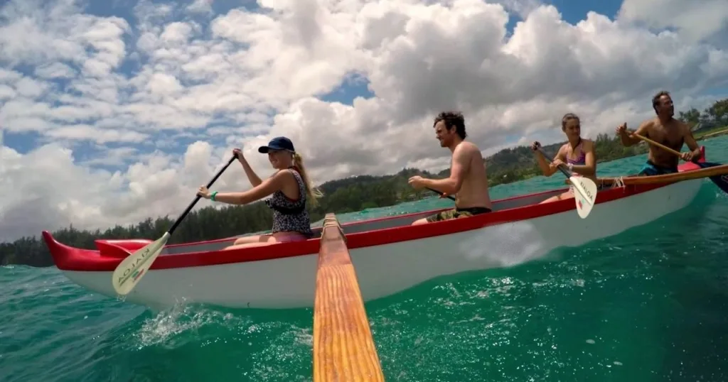 Canoe tour at Kawela Bay with scenic mountain backdrop