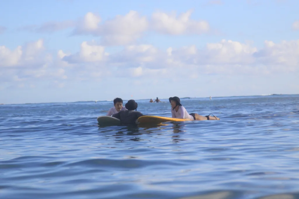 Two surfers receiving semi-private lesson on gentle waves