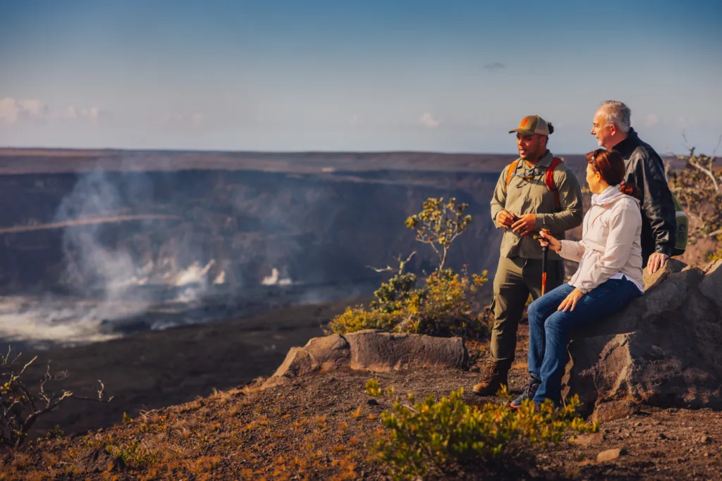 Private tour group exploring volcanic landscapes and waterfalls in Kona