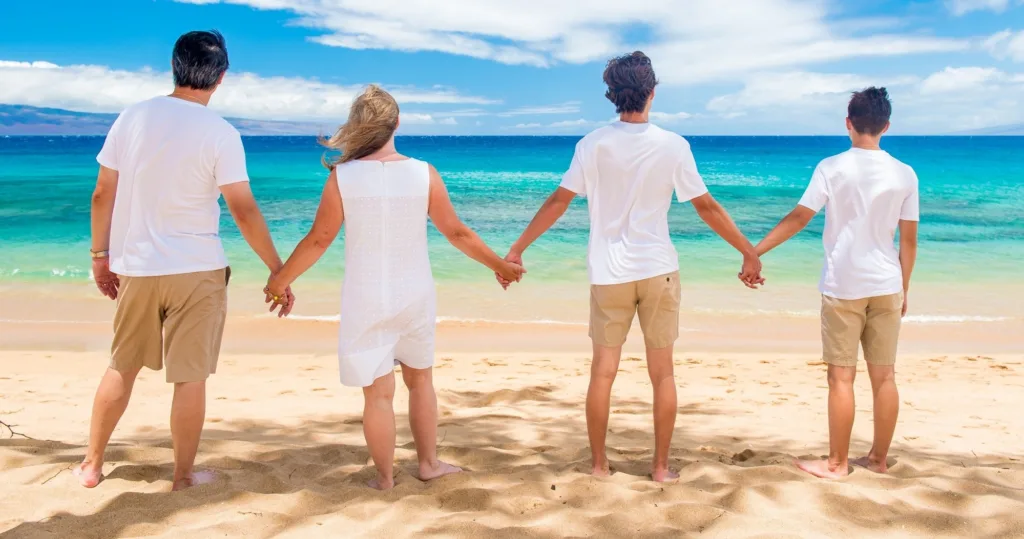 Tourists enjoying a vibrant Maui sunset over the ocean