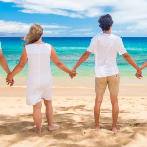 Tourists enjoying a vibrant Maui sunset over the ocean