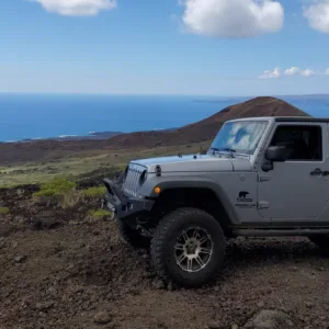 Rugged rocky coastline with waves crashing at sunset