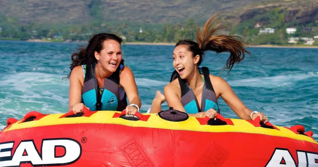 Excited rider sliding down a water bumper tube ride