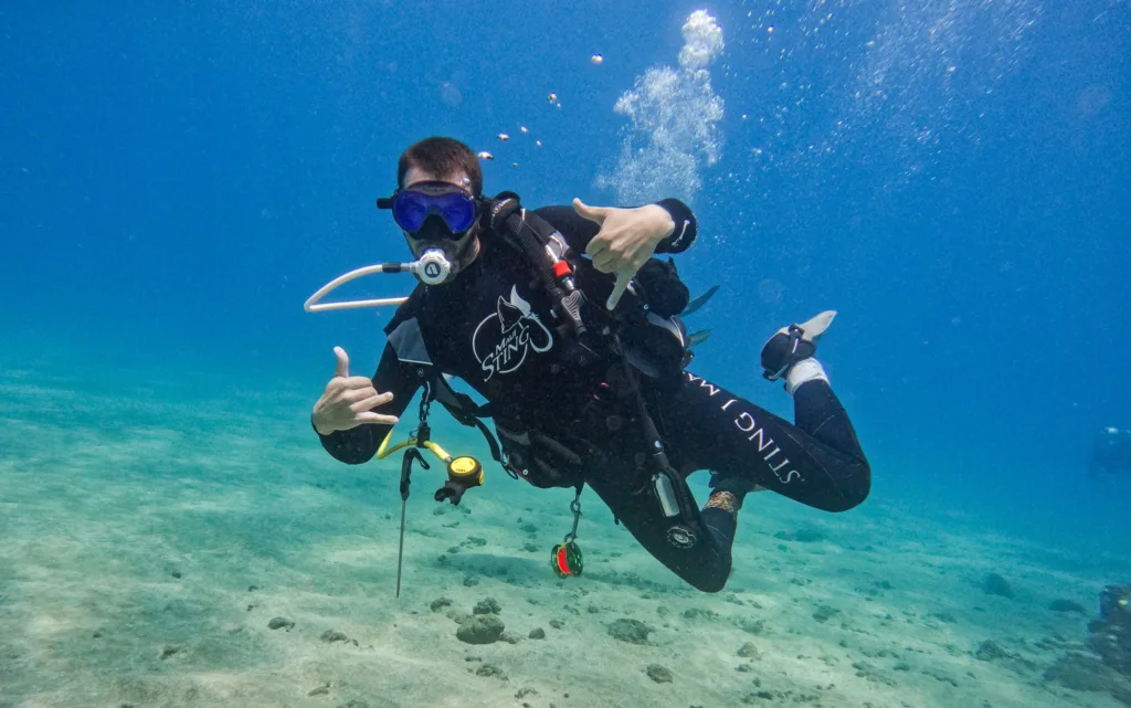 Scuba divers exploring vibrant underwater reefs in Maui