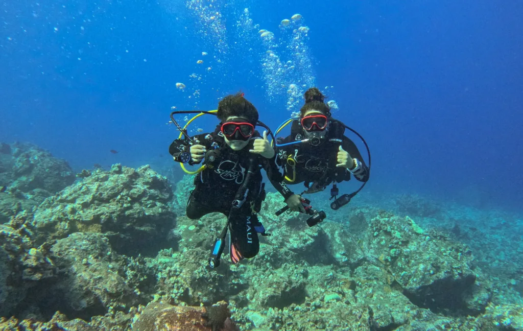 Scuba diver preparing for introductory dive in clear Maui waters
