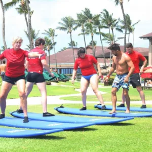 Group of surfers learning waves on Kauai beach