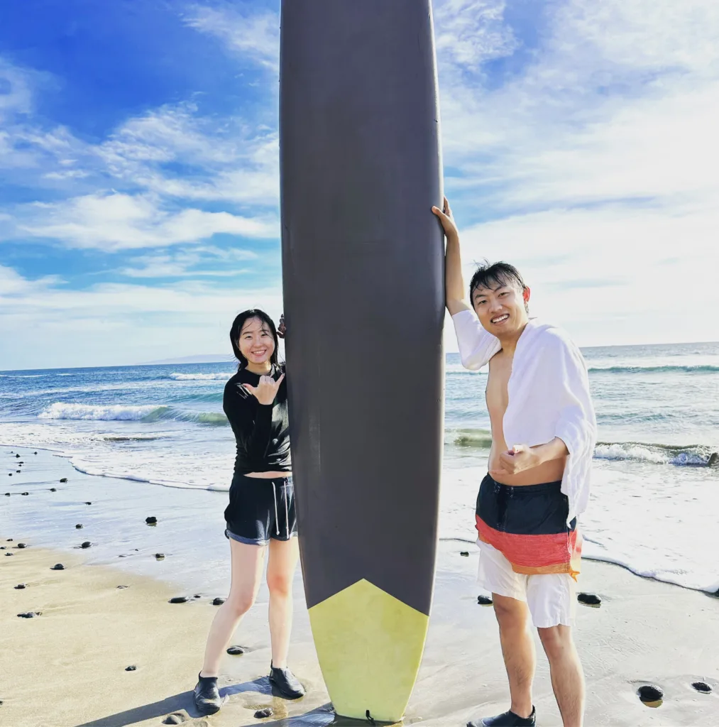 Small group practicing surf techniques on gentle waves