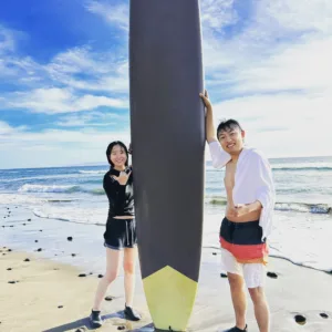 Small group practicing surf techniques on gentle waves