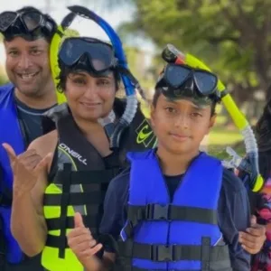 Group of people learning to snorkel in clear water