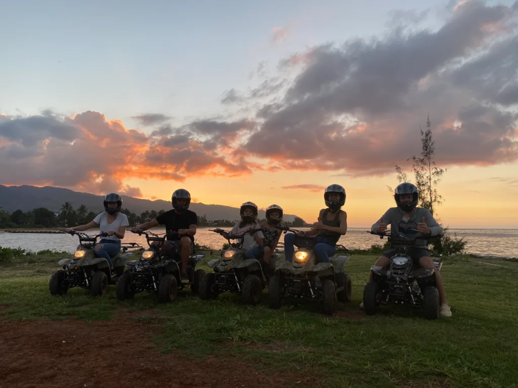 ATV riders exploring a beachfront trail on island tour