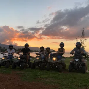 ATV riders exploring a beachfront trail on island tour