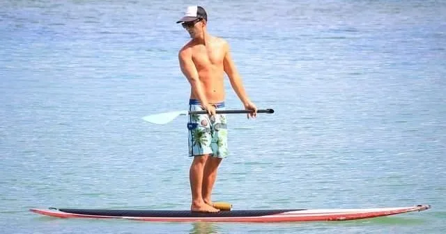 People enjoying paddleboarding on calm island waters