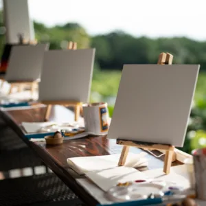People painting and sipping coffee with scenic view