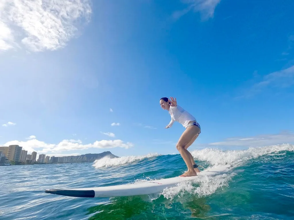 Group of surfers learning to catch waves on sandy beach