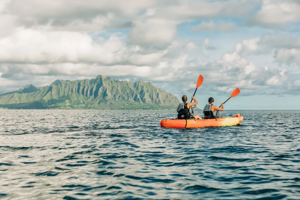 Kayakers paddling over coral reefs in Kaneohe Bay
