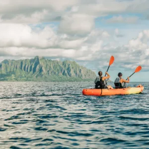 Kayakers paddling over coral reefs in Kaneohe Bay