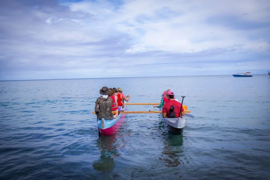 Paddling a canoe around a tropical island