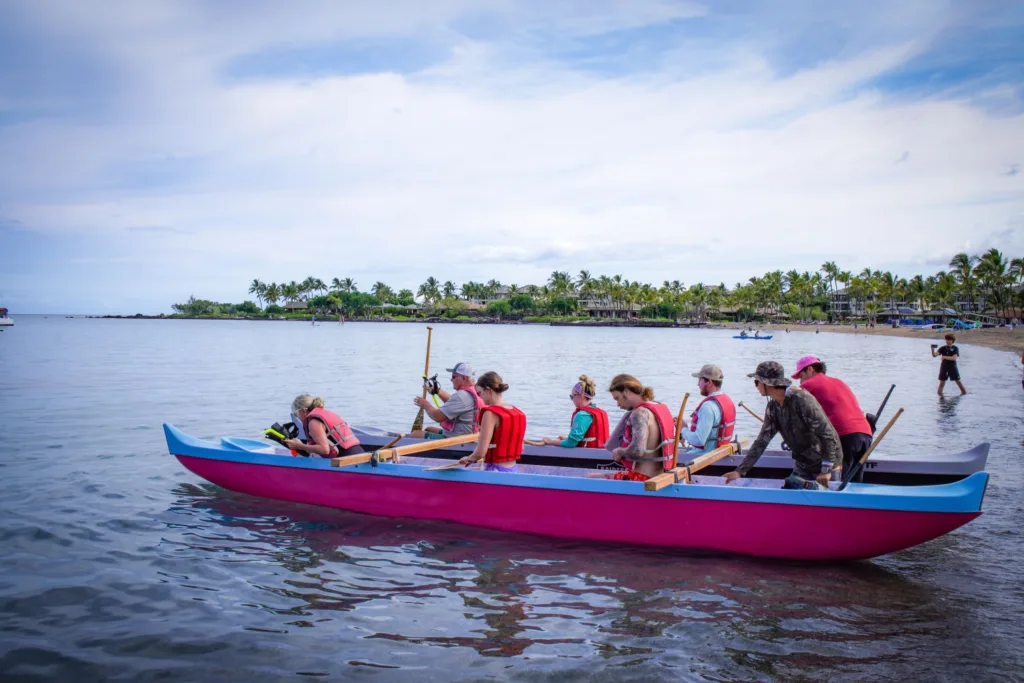 Couple enjoying a peaceful canoe ride on clear ocean waters