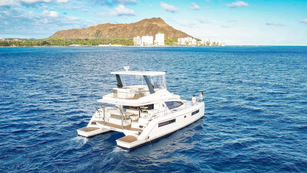 Private charter boat cruising near Waikiki beach shore