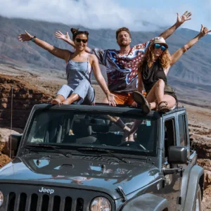 Luxury vehicle driving along scenic Hana coastline