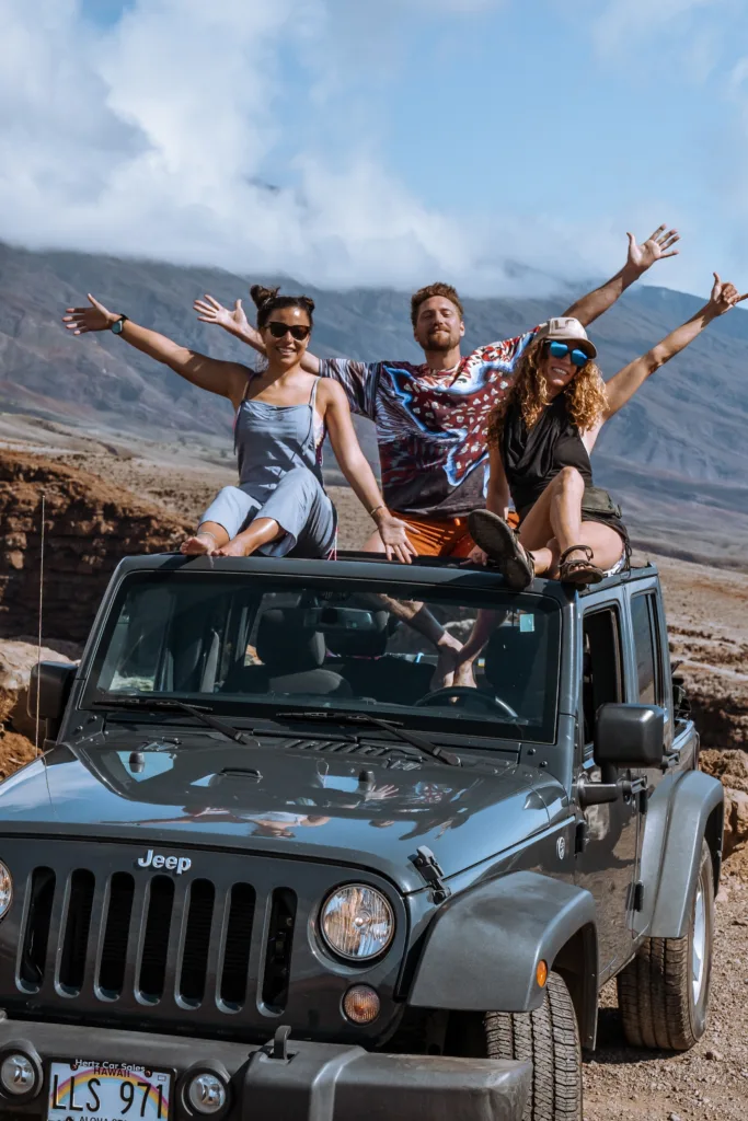 Luxury vehicle driving along scenic Hana coastline