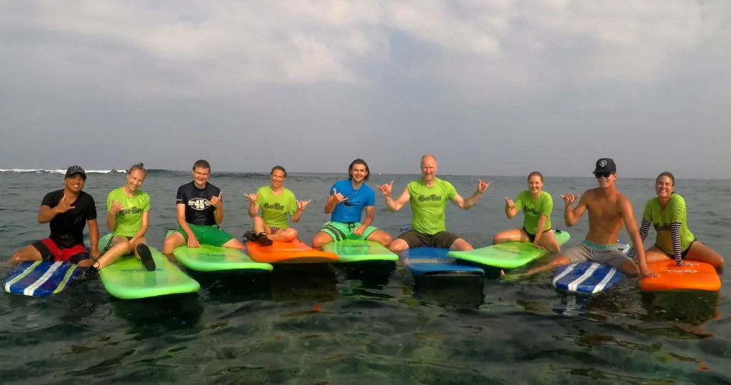 Group of surfers learning waves together in Hawaii