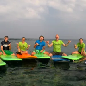 Group of surfers learning waves together in Hawaii