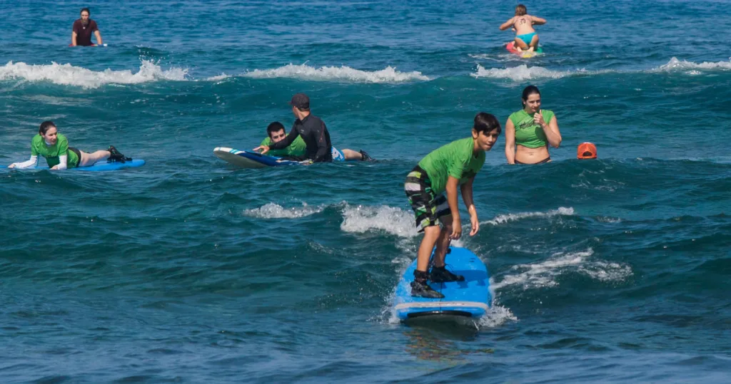 Two students receiving semi-private surf instruction