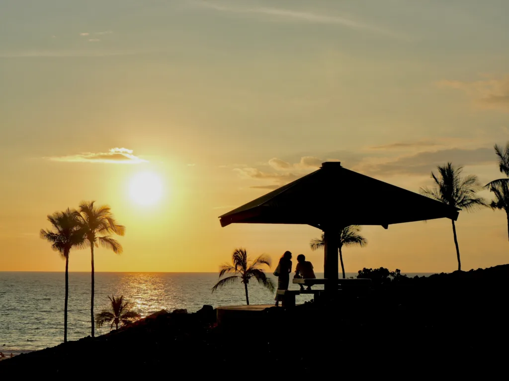 Sunset casting warm colors over tropical coastline