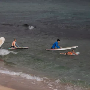 Children learning to surf at Keiki Surf Camp on beach