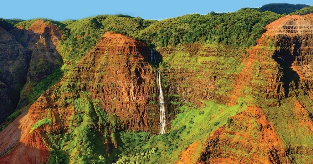 Hikers trekking through Waimea Canyon on Kauai adventure tour