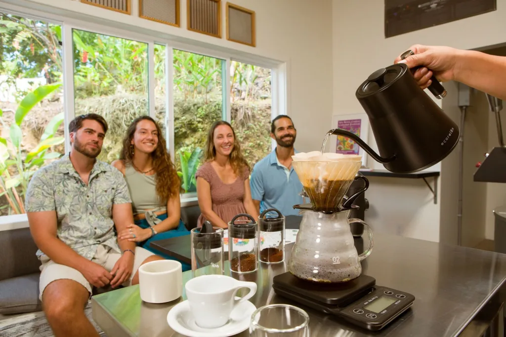 Barista demonstrating coffee brewing techniques to group