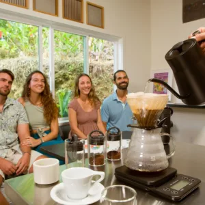 Barista demonstrating coffee brewing techniques to group